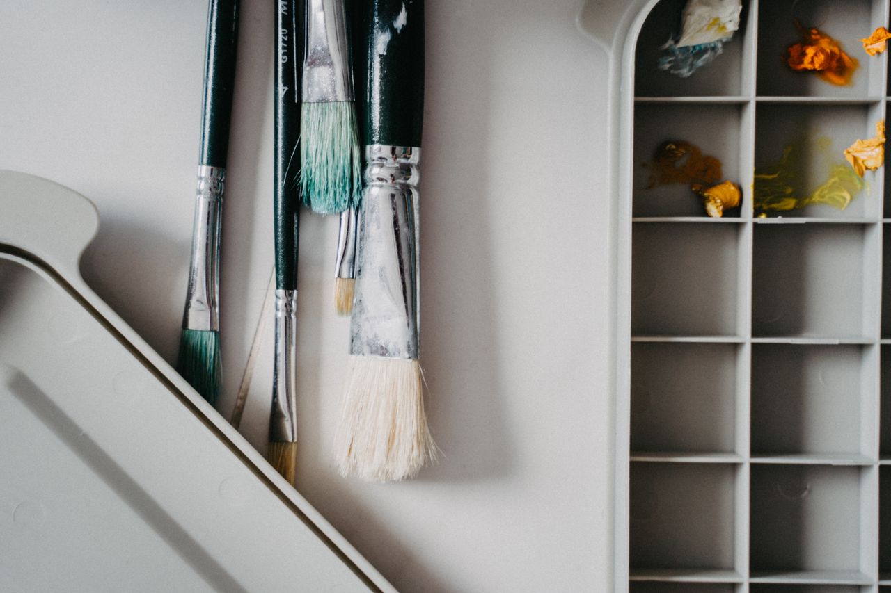 Close-up of paint brushes and palette, ideal for art and craft themes.